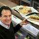 fred deluca posing with Subway sandwich